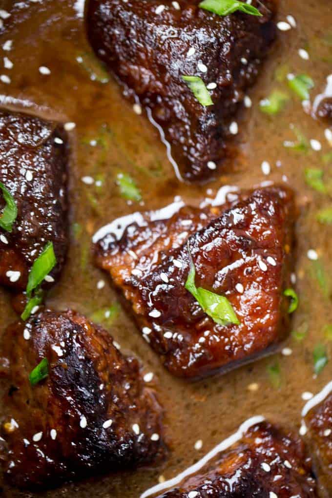 Slow Cooker Korean Short Ribs rosolati e cotti fino a quando la forchetta è tenera con pochi minuti di lavoro di preparazione e tutti i tuoi sapori preferiti.