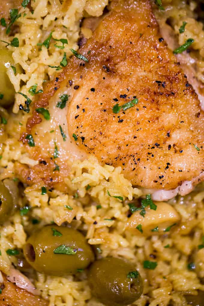 Spanish Olives Chicken and Rice made in a single cast iron skillet is a gorgeous meal made easy with delicious Spanish queen green olives, caramelized onions, garlic and saffron rice.