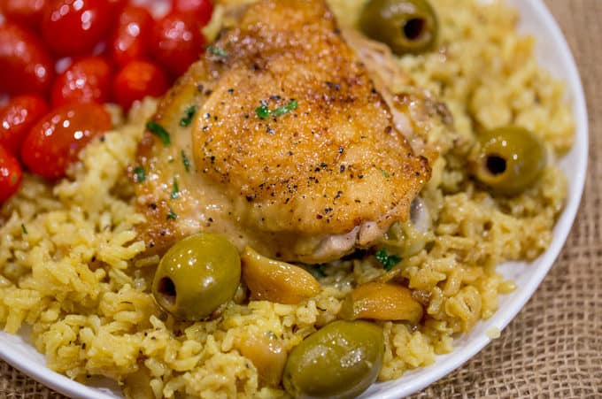 Spanish Olives Chicken and Rice made in a single cast iron skillet is a gorgeous meal made easy with delicious Spanish queen green olives, caramelized onions, garlic and saffron rice.