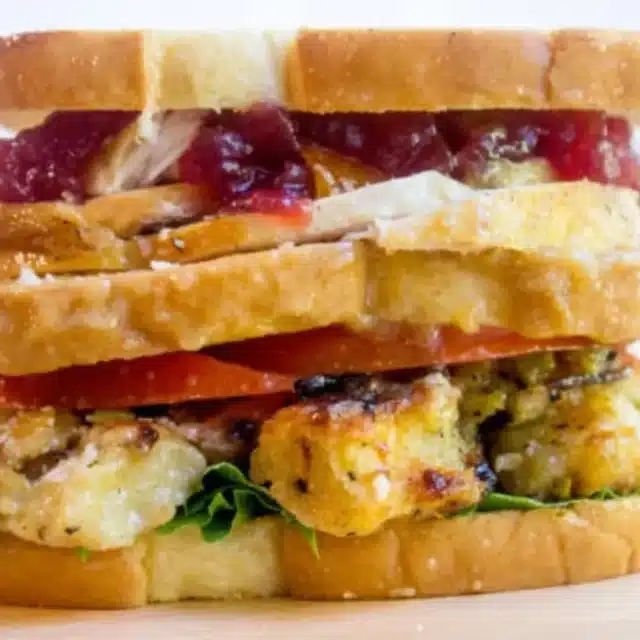 sandwich with layers of turkey, stuffing, veggies and gravy