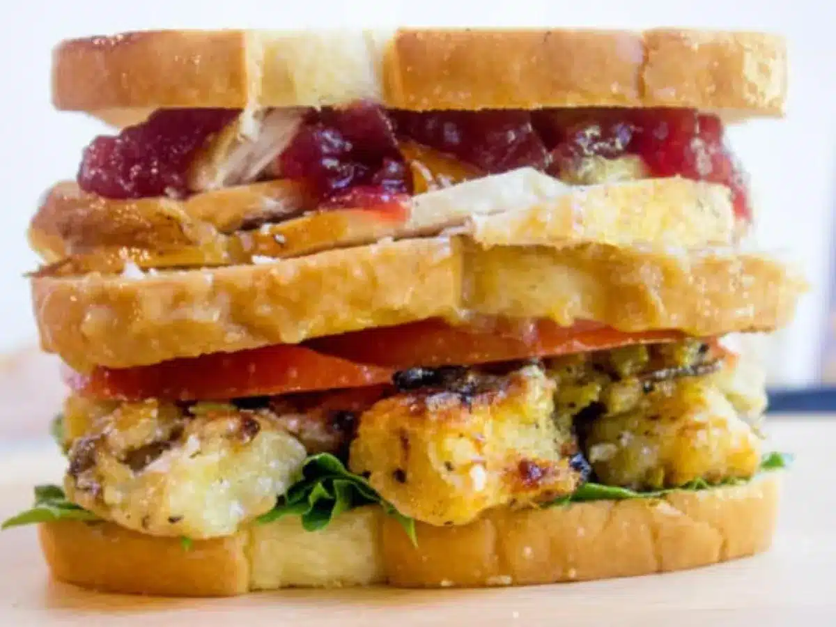 sandwich with layers of turkey, stuffing, veggies and gravy