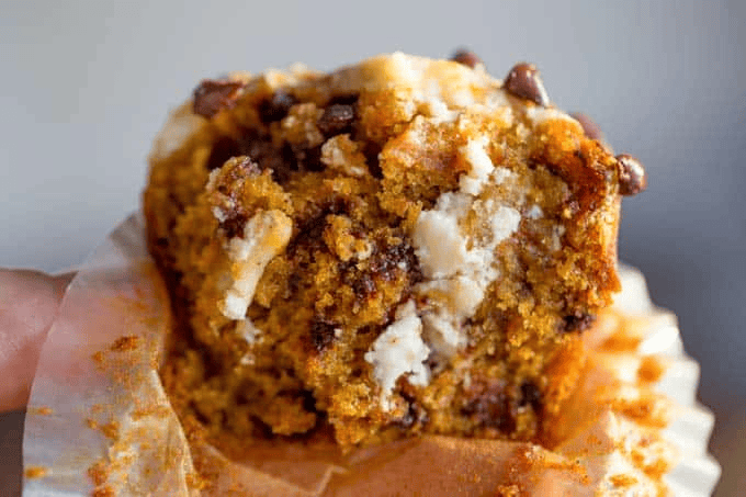 Muffin cut in half with cream cheese showing