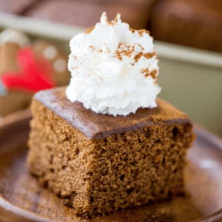 Close up of cake on plate with whipped cream on top