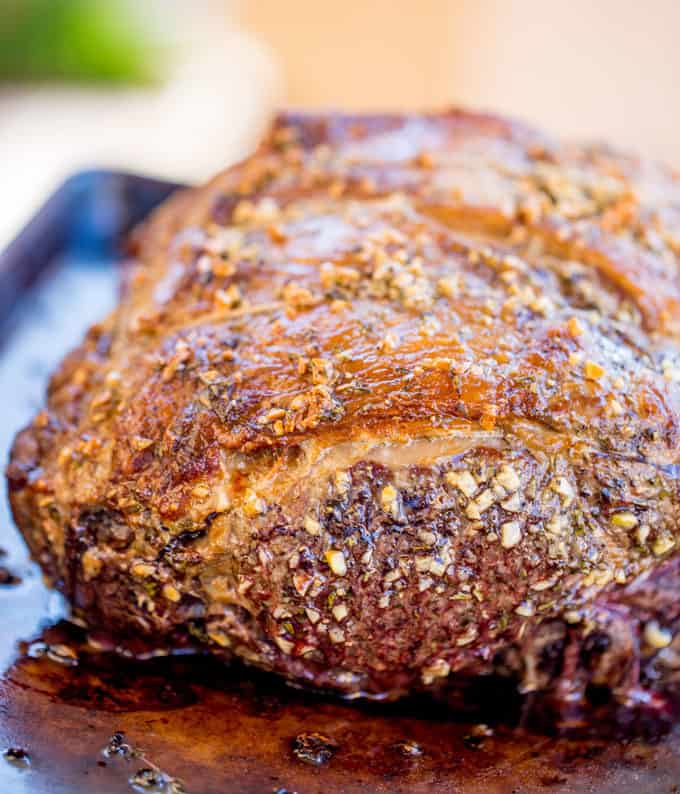 Perfect Garlic Prime Rib made with a garlic, thyme and rosemary crust is gorgeously browned on the outside and a perfect medium on the inside. Topped off with a gremolata it is the perfect show-stopping holiday/event meal! cooked uncut prime rib