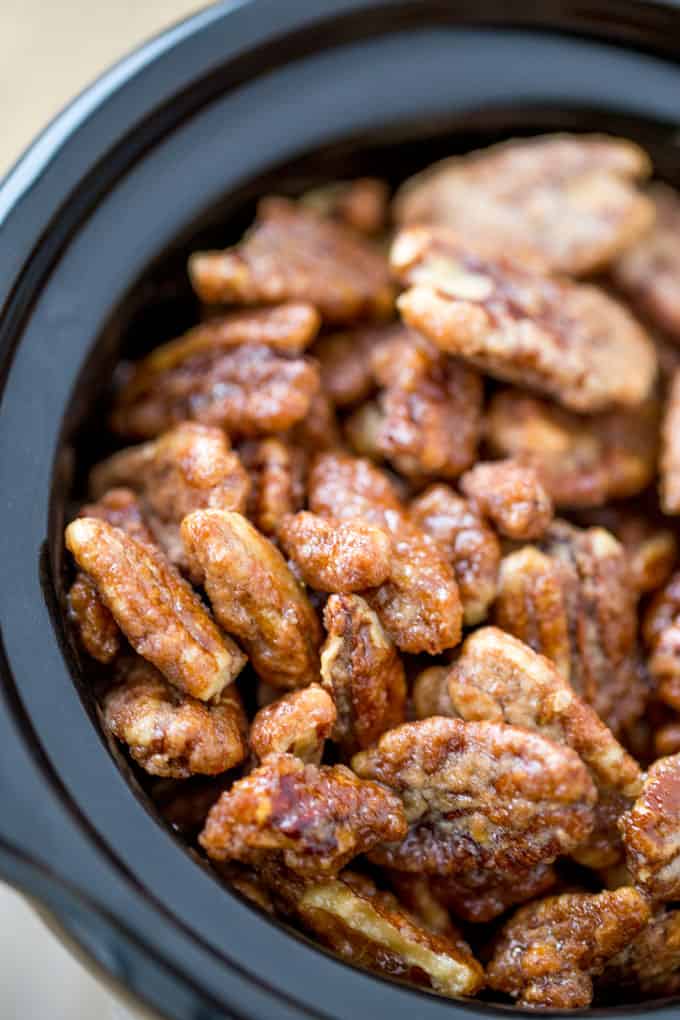 Slow Cooker Candied Cinnamon Pecans are a total breeze to make and will leave your house smelling absolutely delicious! Plus they double as amazing holiday gifts you can make in bulk!