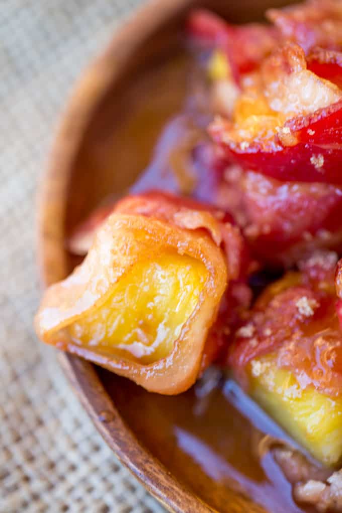 Spicy Sweet Bacon Wrapped Pineapple Bites caramelized with brown sugar and hot sauce make a perfect sticky, sweet, spicy, fruity bacon bite your guest will love in just minutes!