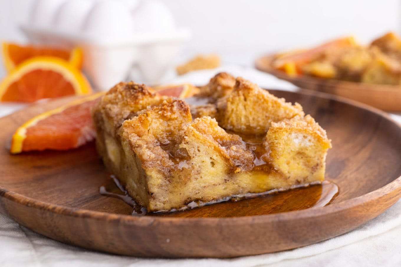 Easy French Toast Bake on wood plate with orange slice