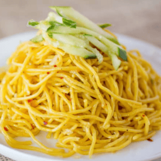 Noodles served on plate and garnished