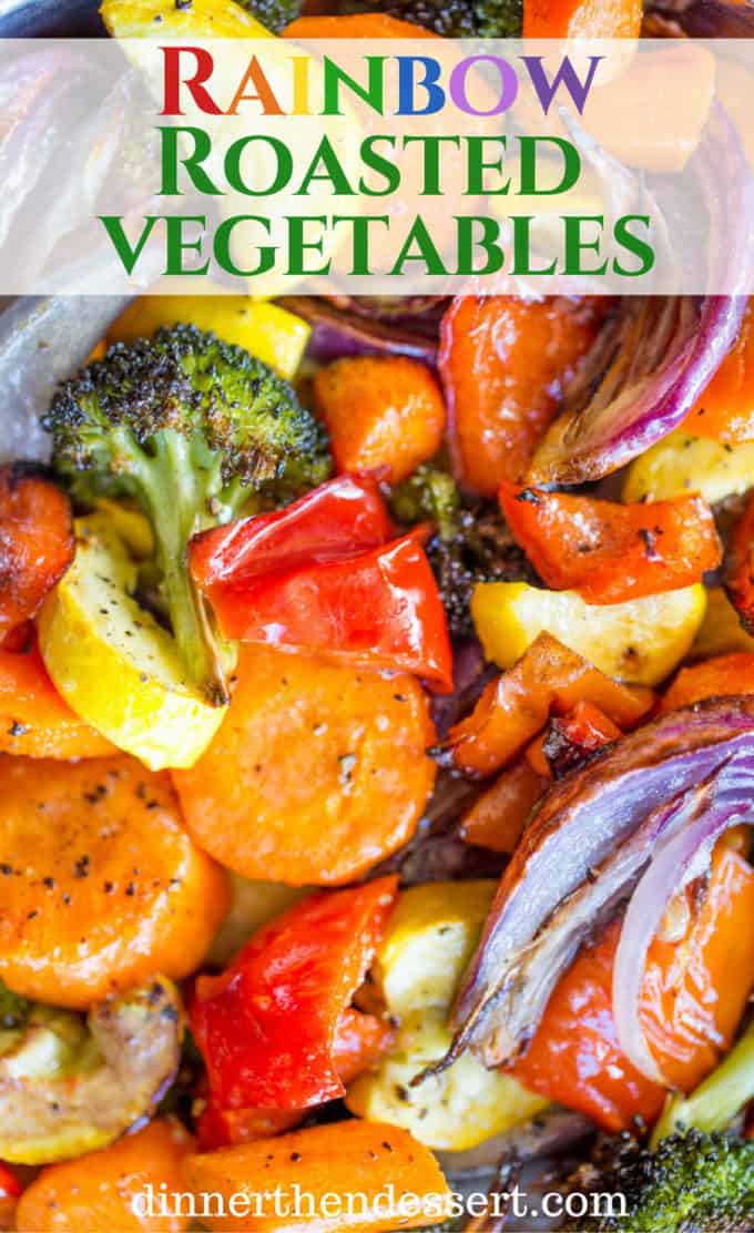Roasted bell peppers, zucchini, and carrots on a baking sheet.