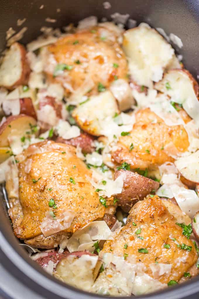 Slow Cooker Garlic Parmesan Chicken and Potatoes takes just a few minutes of prep and five ingredients. Crisp chicken thighs, buttery red potatoes and shaved Parmesan cheese make the perfect easy weeknight meal. 