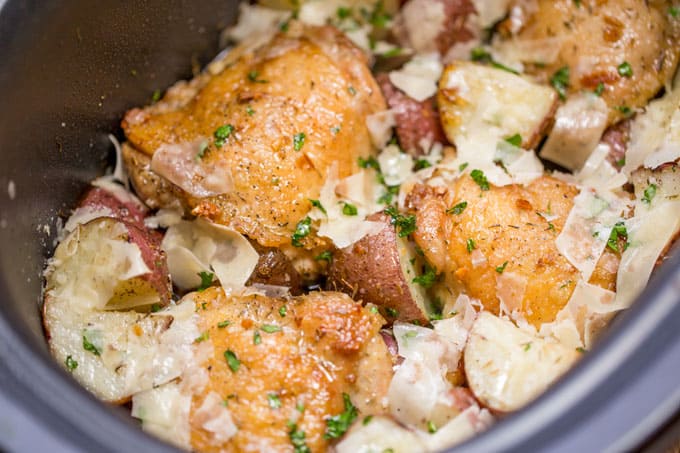 Slow Cooker Garlic Parmesan Chicken and Potatoes takes just a few minutes of prep and five ingredients. Crisp chicken thighs, buttery red potatoes and shaved Parmesan cheese make the perfect easy weeknight meal. 