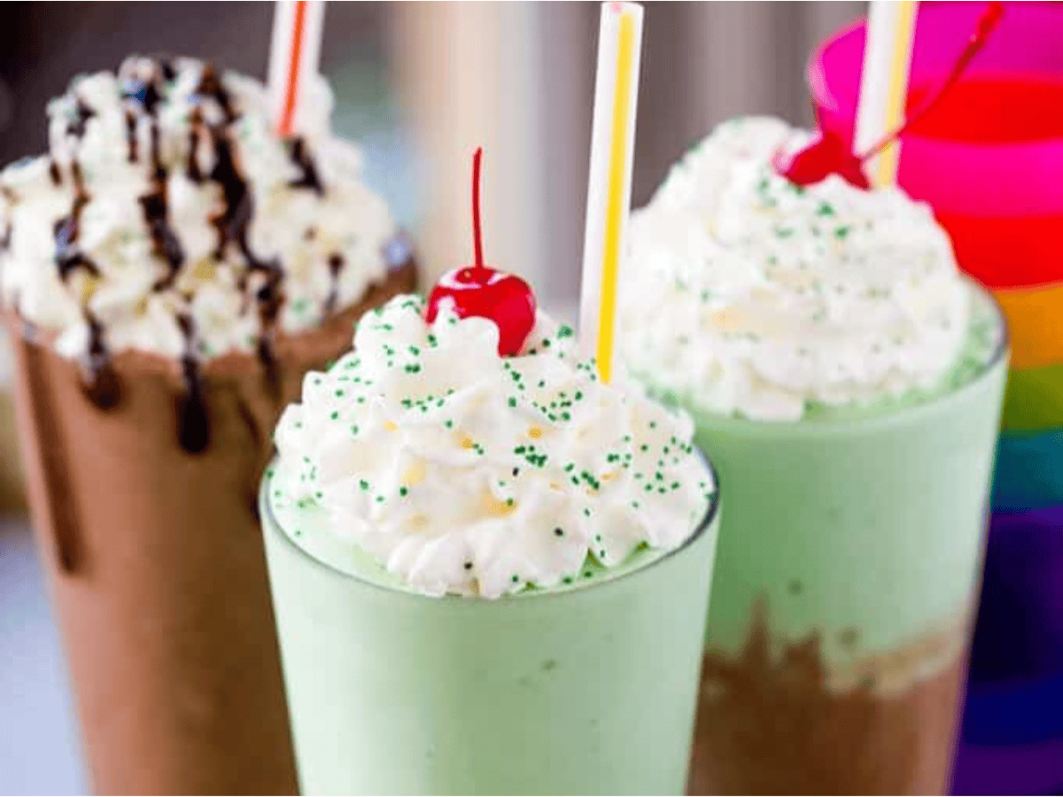 All three variations of the shakes with toppings and rainbow cups in the background