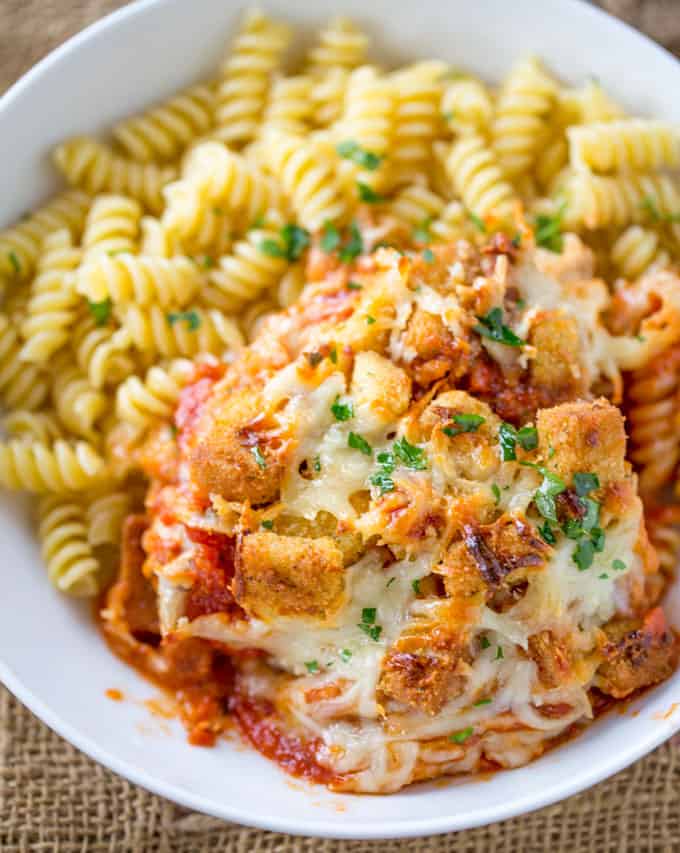 Chicken Parmesan Casserole is a quick weeknight meal that is ready to bake in ten minutes with mozzarella, Parmesan, tomato sauce and a crouton crunch topping for the perfect Chicken Parmesan flavor! 