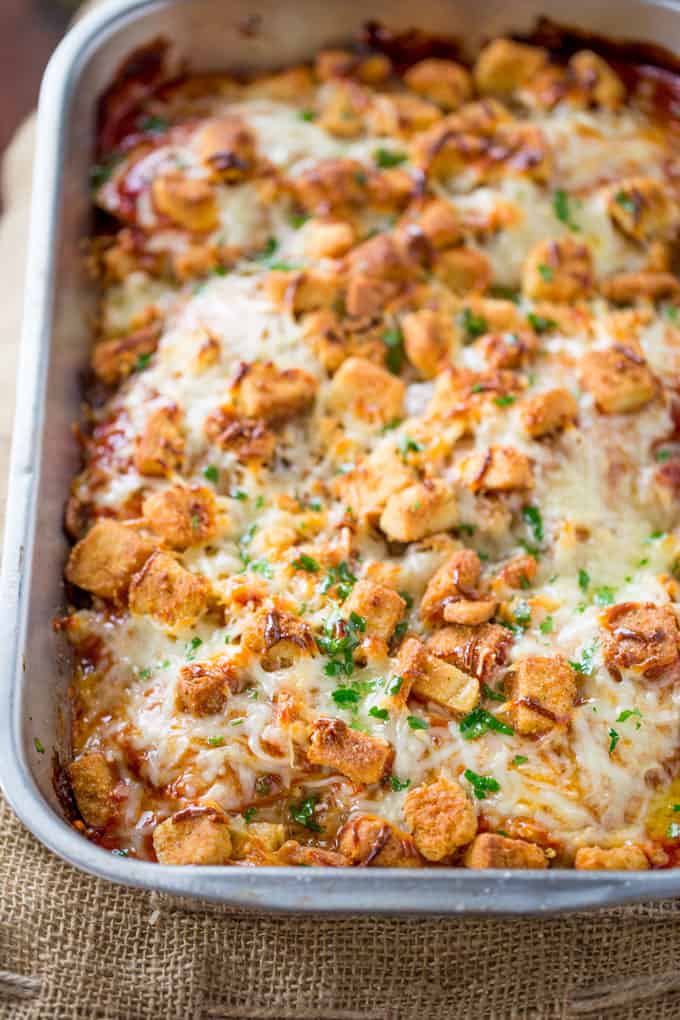 Chicken Parmesan Casserole is a quick weeknight meal that is ready to bake in ten minutes with mozzarella, Parmesan, tomato sauce and a crouton crunch topping for the perfect Chicken Parmesan flavor! 