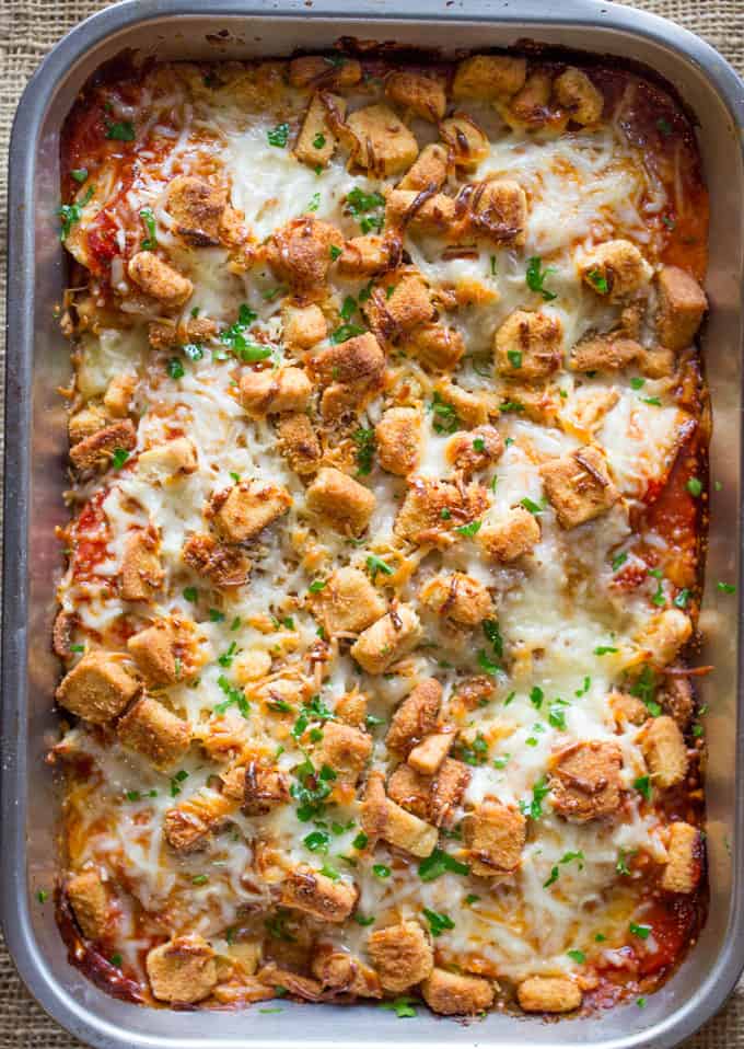 Chicken Parmesan Casserole is a quick weeknight meal that is ready to bake in ten minutes with mozzarella, Parmesan, tomato sauce and a crouton crunch topping for the perfect Chicken Parmesan flavor! 
