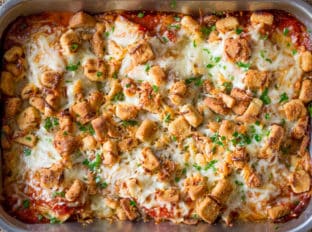 Chicken Parmesan Casserole is a quick weeknight meal that is ready to bake in ten minutes with mozzarella, Parmesan, tomato sauce and a crouton crunch topping for the perfect Chicken Parmesan flavor!