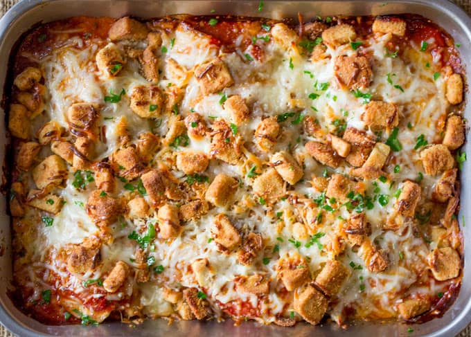 Chicken Parmesan Casserole is a quick weeknight meal that is ready to bake in ten minutes with mozzarella, Parmesan, tomato sauce and a crouton crunch topping for the perfect Chicken Parmesan flavor! 