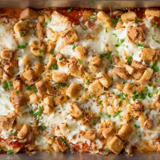 cooked poultry baked in dairy and sauce topped with green garnish
