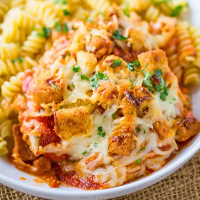 Plated Italian chicken casserole serrving over pasta
