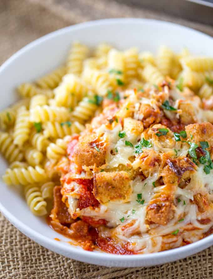 Chicken Parmesan Casserole is a quick weeknight meal that is ready to bake in ten minutes with mozzarella, Parmesan, tomato sauce and a crouton crunch topping for the perfect Chicken Parmesan flavor! 