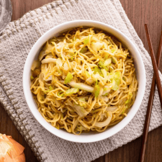 Chow mein in white bowl with chop sticks