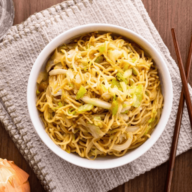 Chow mein in white bowl with chop sticks