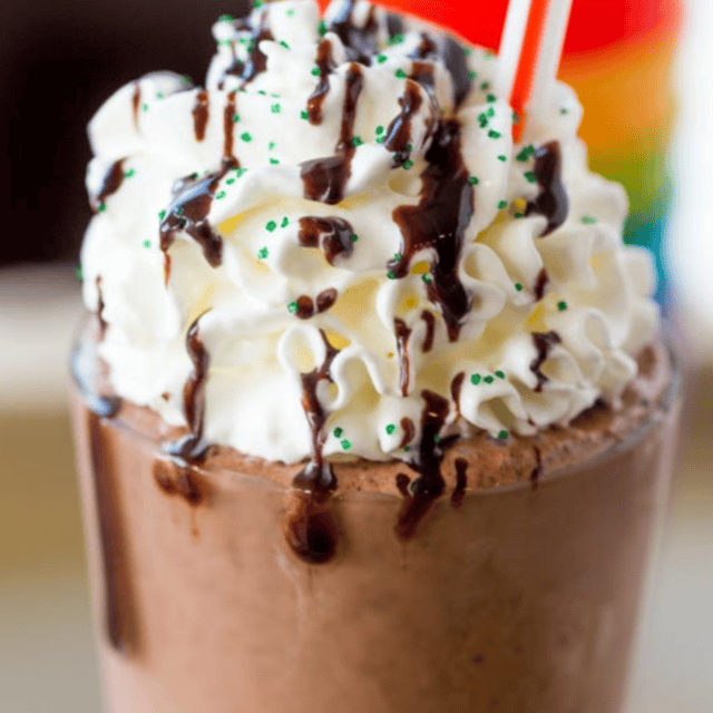 Milkshake with whipped cream and chocolate drizzle