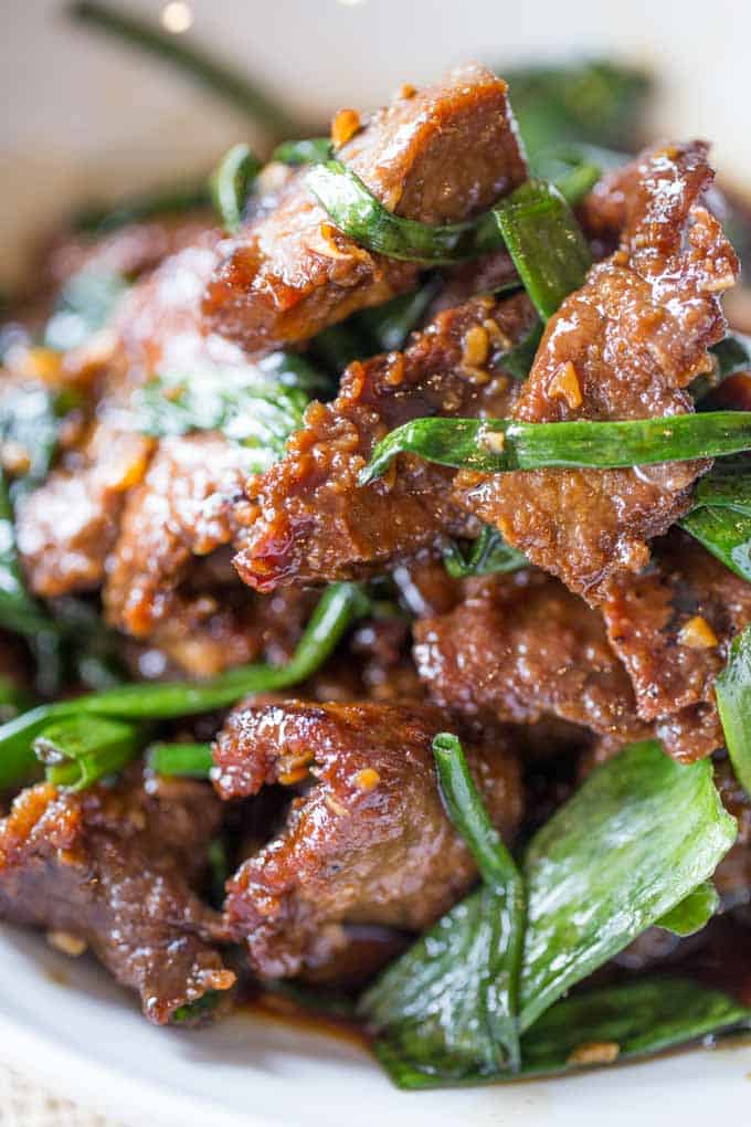 Mongolian Beef cooked steak pieces with green onions closeup