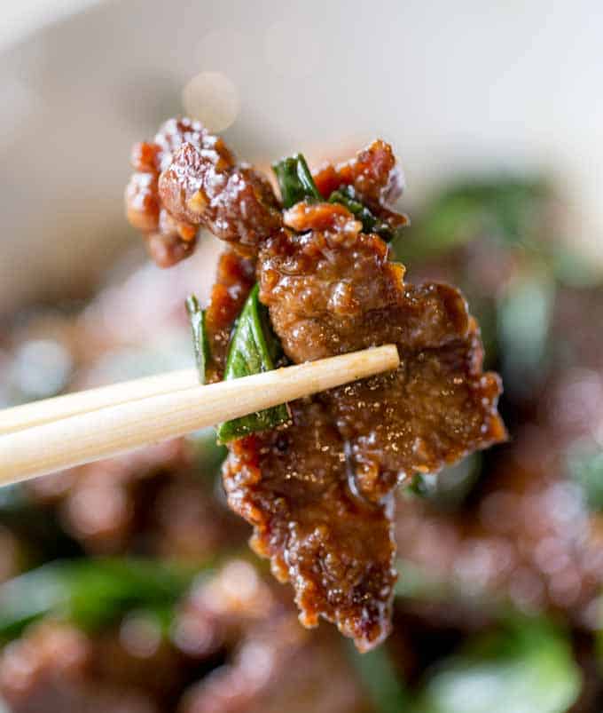 Mongolian Beef cooked with chopsticks holding one piece of steak