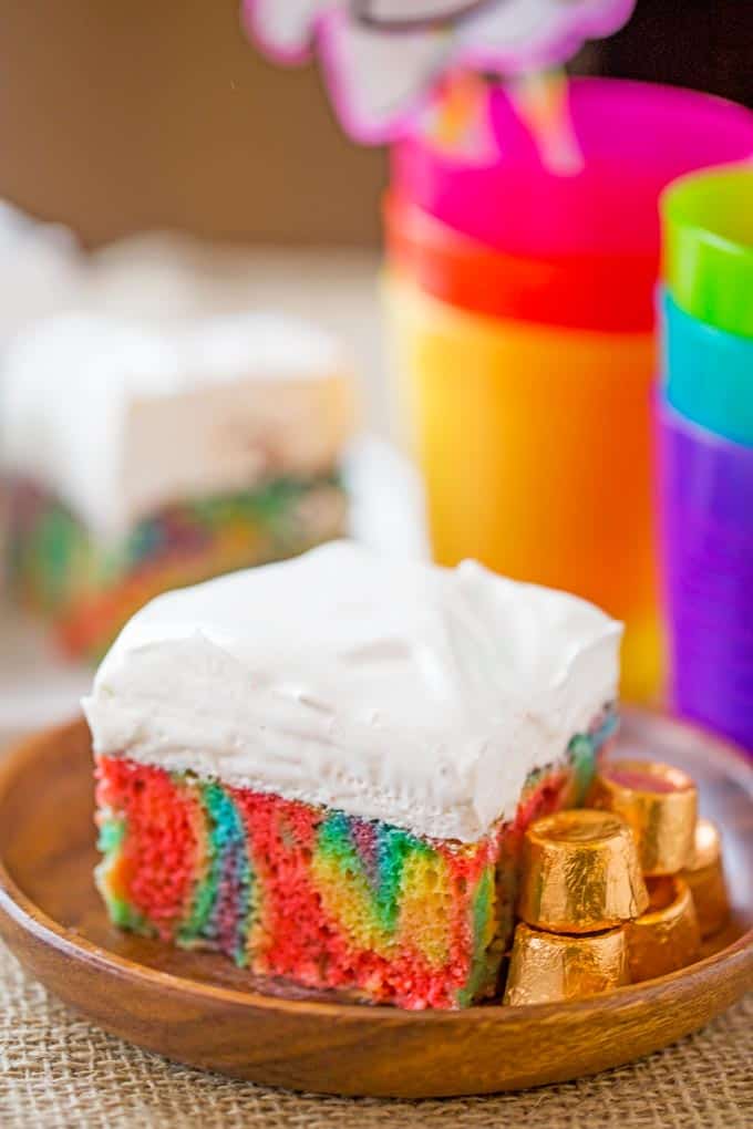 Rainbow Poke Cake With Whipped Cream made with no cake mix. Condensed milk makes this poke cake super moist and fluffy stabilized whipped cream won't melt!