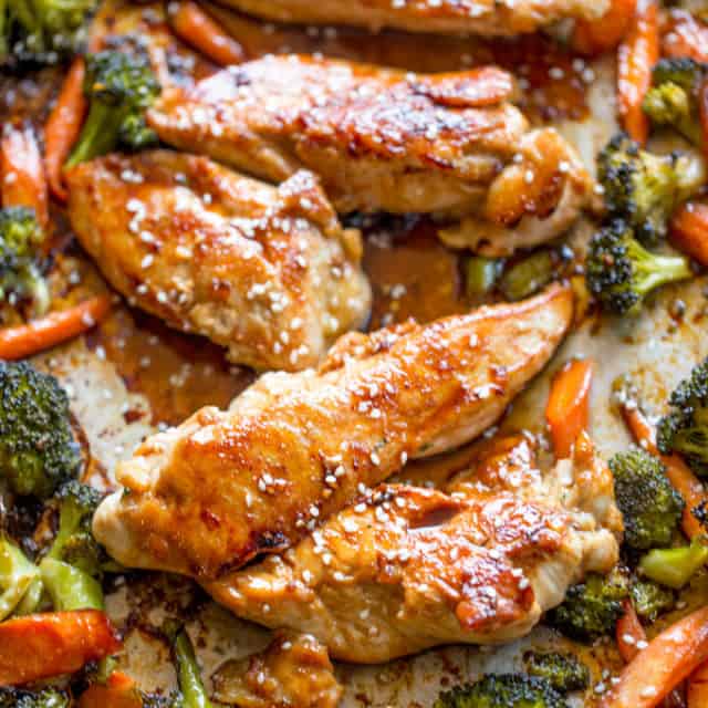roasted Korean chicken with colorful vegetables on a sheet pan