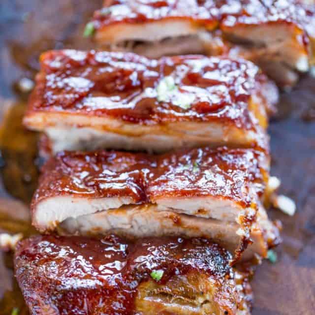 Slow Cooker Barbecue Ribs that are fall off the bone tender made with a homemade rub and easy tangy bbq sauce. These are perfect for your summer barbecues!