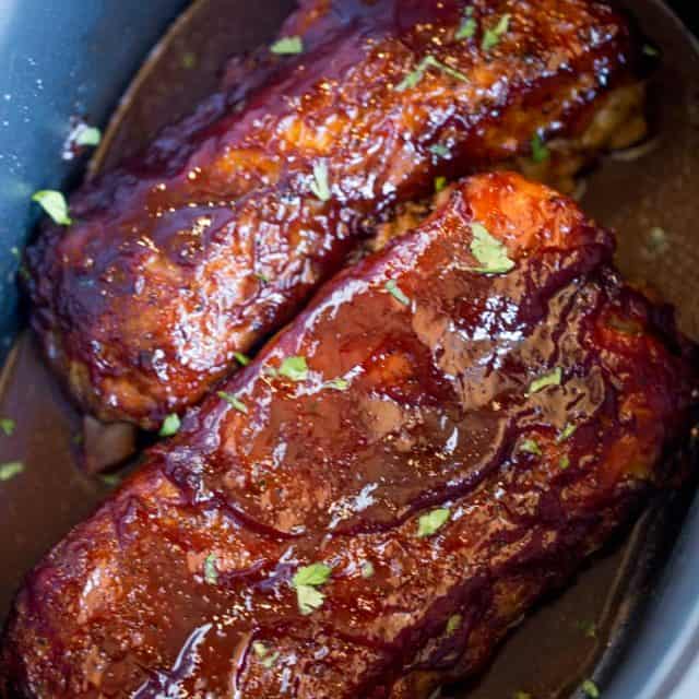 Slow Cooker Barbecue Ribs that are fall off the bone tender made with a homemade rub and easy tangy bbq sauce. These are perfect for your summer barbecues!