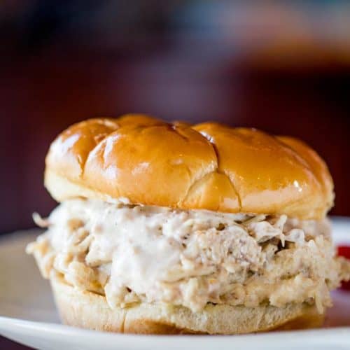 Slow Cooker Chicken Caesar Sandwiches made with easy homemade caesar dressing, Parmesan Cheese and a buttery hamburger bun.