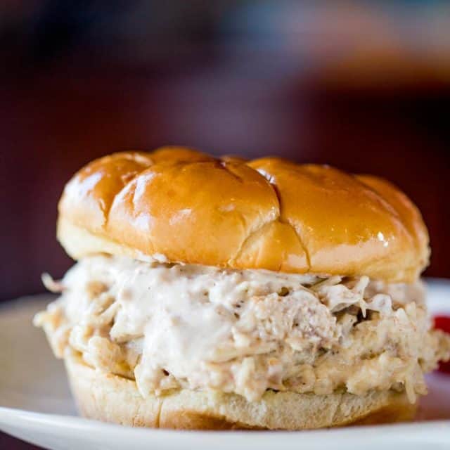 Slow Cooker Chicken Caesar Sandwiches made with easy homemade caesar dressing, Parmesan Cheese and a buttery hamburger bun.