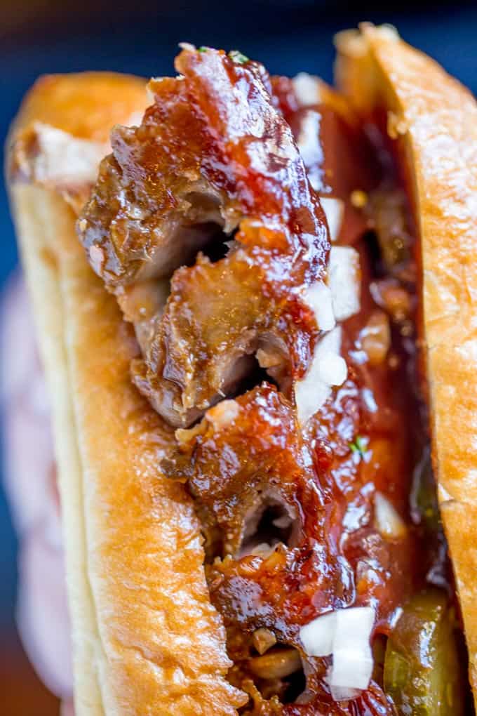 Slow Cooker McRib Sandwiches with an amazing baby back rib meat topped with the classic McDonald's bbq sauce, onions and pickles.
