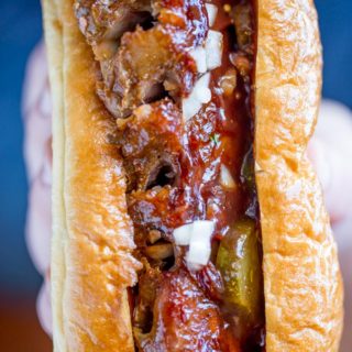 Slow Cooker McRib Sandwiches with an amazing baby back rib meat topped with the classic McDonald's bbq sauce, onions and pickles.