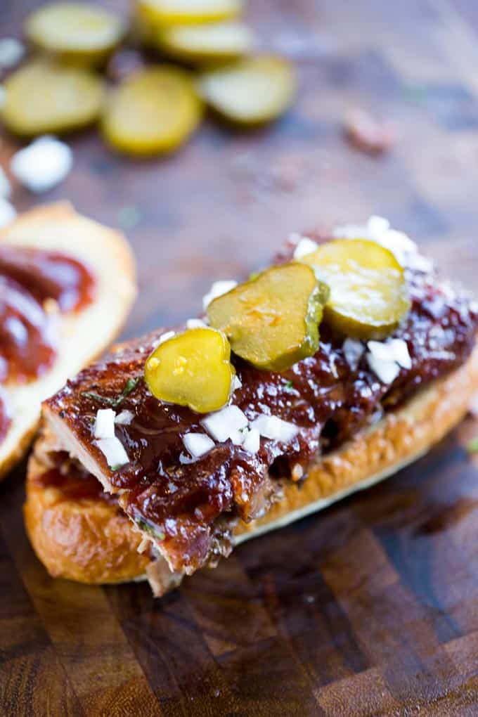 Slow Cooker McRib Sandwiches with an amazing baby back rib meat topped with the classic McDonald's bbq sauce, onions and pickles.