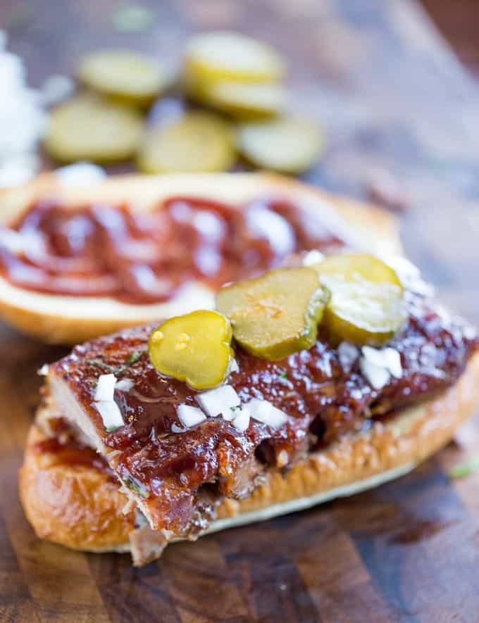 Slow Cooker McRib Sandwiches with an amazing baby back rib meat topped with the classic McDonald's bbq sauce, onions and pickles.