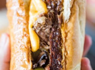 Slow Cooker Philly Cheese Steak Sandwiches that are so tender and flavorful you'll feel like you're in Philly. Perfect for a crowd!