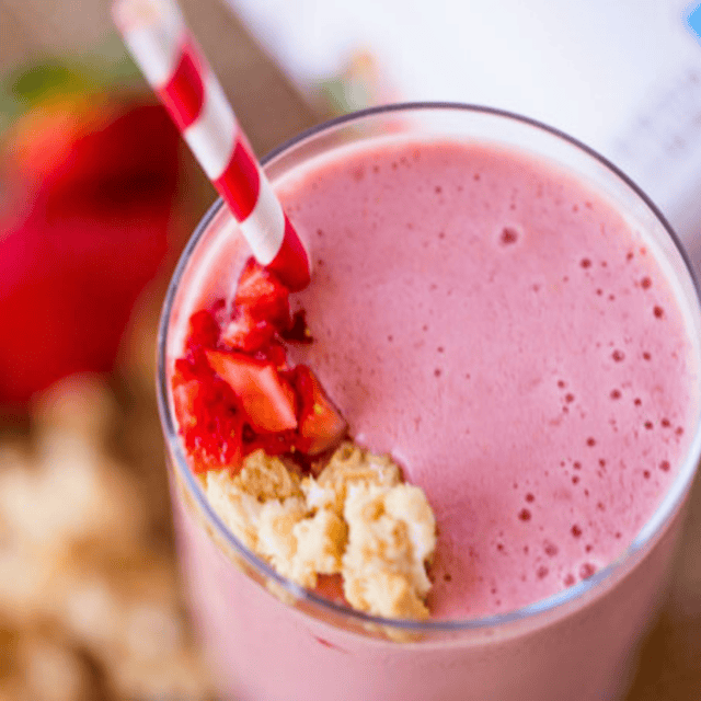 berry crumb cake blended drink in a cup with a straw on the table