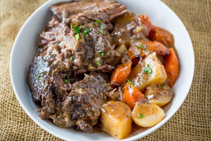 Ultimate Slow Cooker Pot Roast that leaves you with tender meat, vegetables and a built in gravy to enjoy them all with in just 15 minutes of prep! Perfect weeknight dinner!