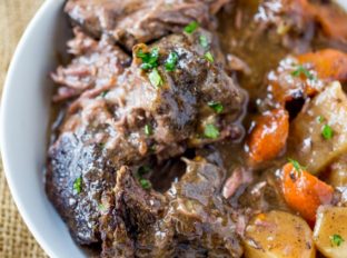 Ultimate Slow Cooker Pot Roast that leaves you with tender meat, vegetables and a built in gravy to enjoy them all with in just 15 minutes of prep! Perfect weeknight dinner!