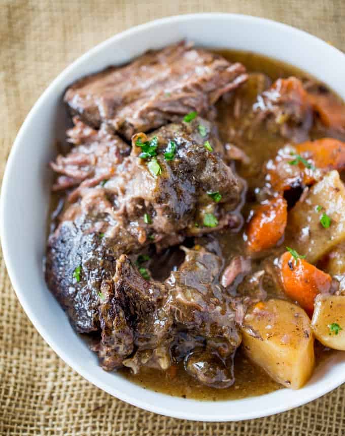 Ultimate Slow Cooker Pot Roast that leaves you with tender meat, vegetables and a built in gravy to enjoy them all with in just 15 minutes of prep! Perfect weeknight dinner!