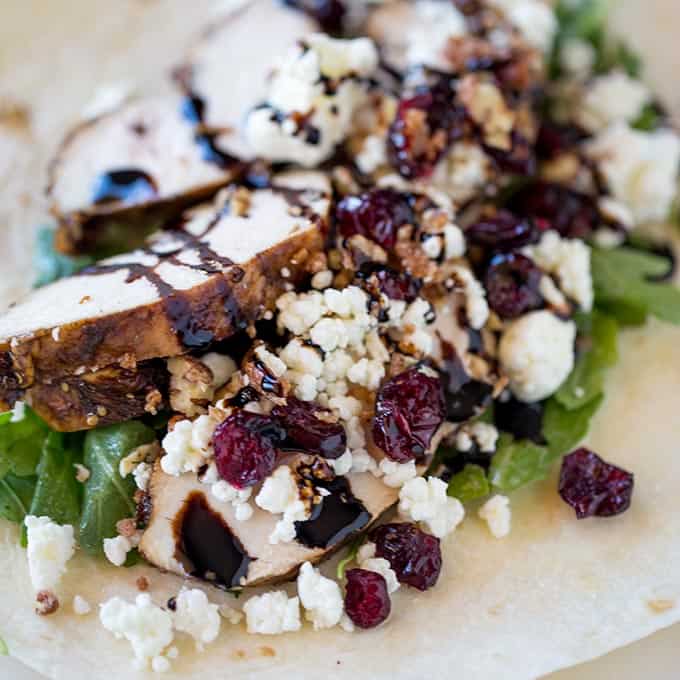 Balsamic Chicken Goat Cheese Wraps made with balsamic roasted chicken breasts, arugula, pecans, cranberries and goat cheese and topped with a wonderful balsamic glaze. The perfect lunch on the go.