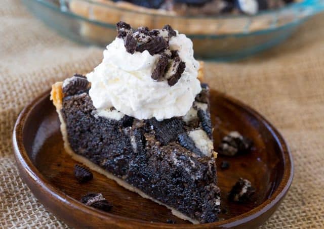 slice of oreo pie on plate whipped cream topping
