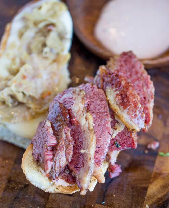 Slow Cooker Reuben Sandwiches are perfect for leftover corned beef after your St. Patrick's Day dinner with a quick sauerkraut, Swiss cheese and thousand island dressing.
