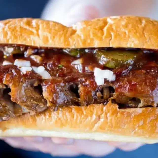 Full view of hands holding up sandwich