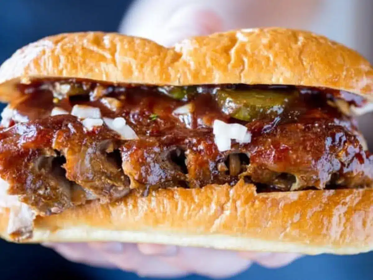 Full view of hands holding up sandwich