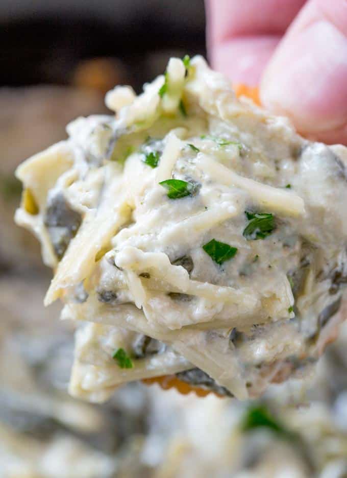 Easy Slow Cooker Spinach Artichoke Dip heaped on cracker